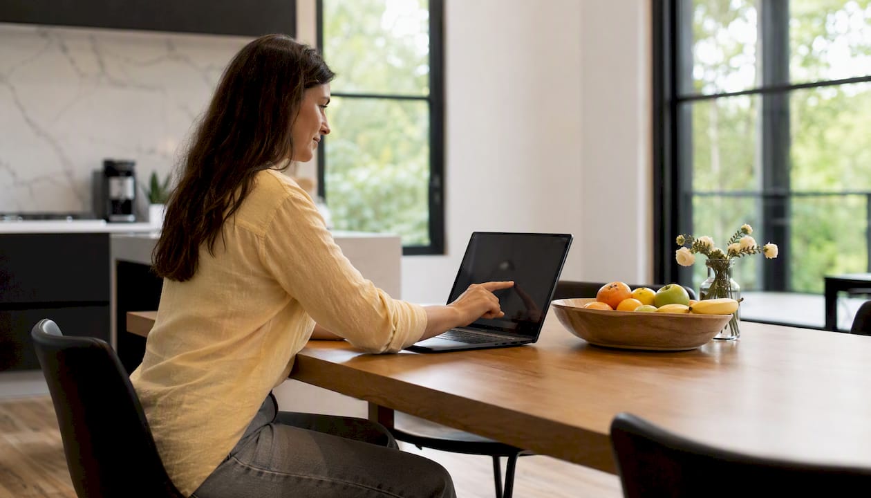 Hands interacting with online learning platform on laptop